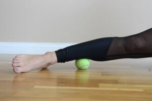 image of using a tennis ball to release a calf muscle